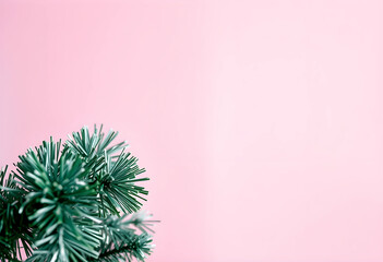 Fototapeta premium Close-up of green Christmas tinsel on pink background