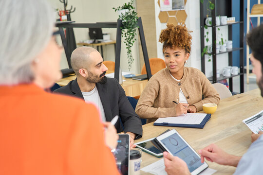 Colleagues discussing business strategy at the office desk