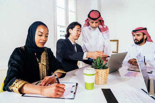 International business team discussing strategy in a Riyadh office