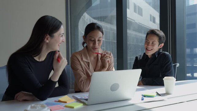 Group of diverse business team collaborating discussing on creative project using laptop. Professionals businesspeople brainstorming startup strategy during informal meeting in corporate workspace