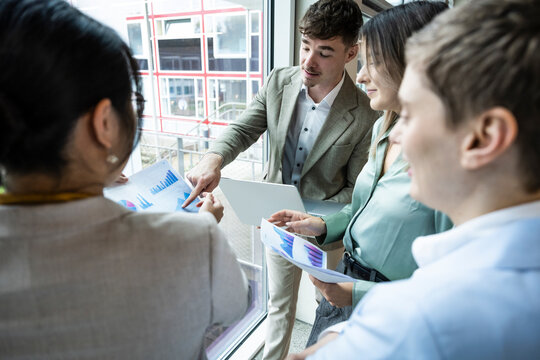 Business team collaborating and discussing strategy in a modern office