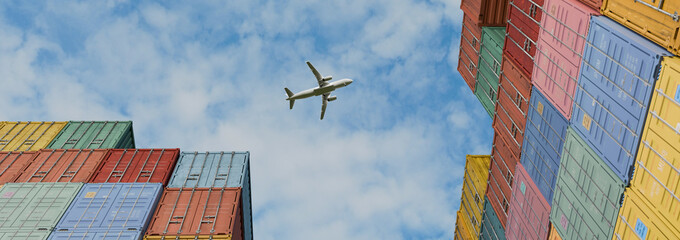 Naklejka premium Airplane Flying Over Colorful Stacked Shipping Containers at Cargo Port, Low Angle View of Global Logistics