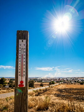 Hot weather - Summer heat background - Thermometer sky and sun rays