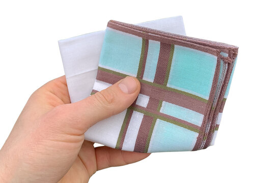 A close-up of a hand holding folded cotton handkerchief isolated on a white background.