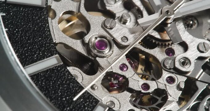 Macro close up of mechanical skeleton watch movement with gears in motion