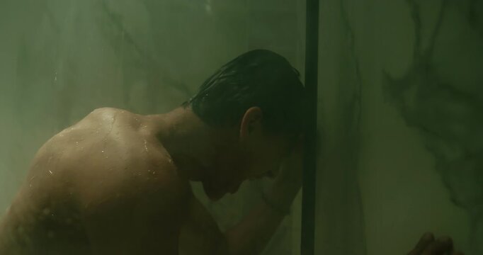 Man stand under hot water stream shower bathroom screaming. Depressed alone guy cry feel grief. Sad young person shouting, yell, loneliness, solitude. Melancholy mood, introspection, inner struggle.