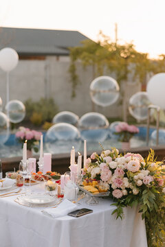 Outdoor birthday dinner party by swimming pool