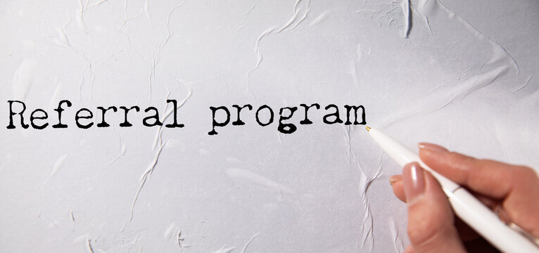 referral program text on torn paper