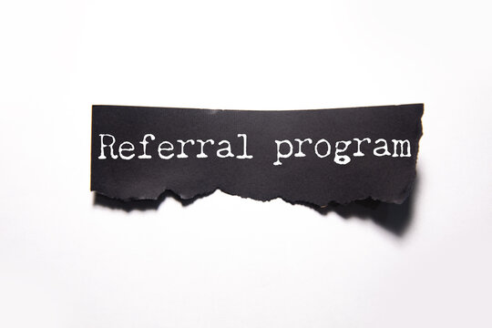 referral program text on torn paper