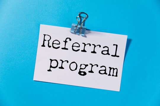 referral program text on torn paper