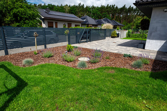 Modern suburban house garden entrance with driveway paving