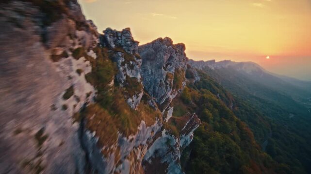 FPV Drone Flight Along Limestone Ridge Above Autumn Forest at Sunset