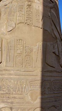 Kom Ombo temple ruins with double columns and composite capitals against clear blue sky in Egypt, ancient Ptolemaic architecture dedicated to Sobek and Horus with damaged walls