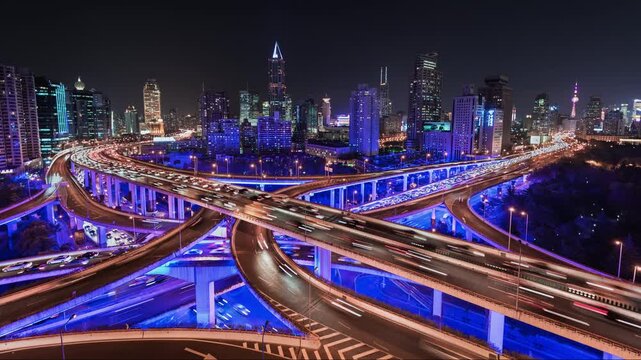 Time lapse of busy elevated road intersection with commuters with neon lighting, at night, Asia, China, Shanghai