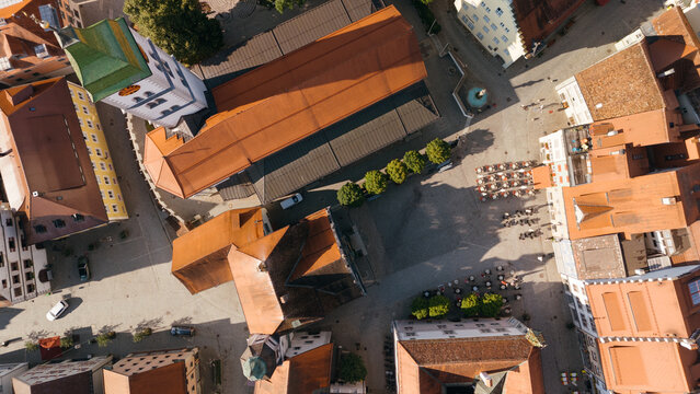 Bird's eye view of city square and rooftops