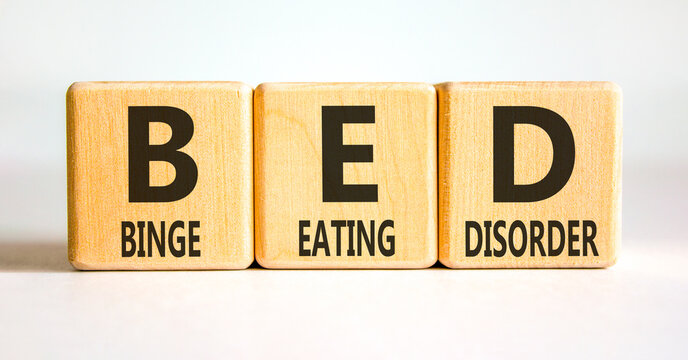 BED binge eating disorder symbol. Concept words BED binge eating disorder on beautiful wooden blocks. Beautiful white background. Medical BED binge eating disorder concept. Copy space.