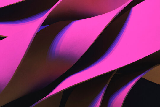 Wavy shapes illuminated by pink light, studio shot photo