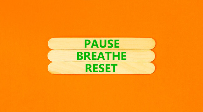 Pause breathe reset words symbol. Concept words Pause breathe reset on beautiful wooden sticks. Beautiful orange background. Business support motivational and pause breathe reset concept. Copy space.