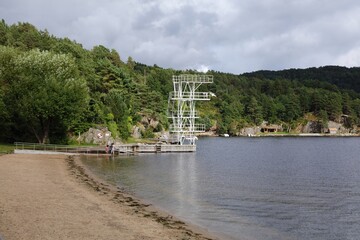 Fototapeta premium Norway beach in summer. Gronnes beach and diving tower in Flekkefjord, Vest-Agder.