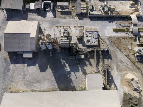 Aerial view of Ergon Asfaltos Progreso industrial facility featuring storage silos, processing buildings, and conveyor systems in Progreso, Yucatan, Mexico.