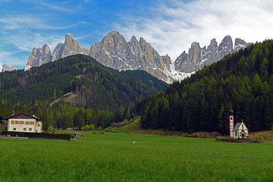 Church of San Giovanni in Ranui, an iconic baroque chapel located in Val di Funes, in South Tyrol. In the background stand the Odle (Geisler), a famous mountain group of the Dolomites, recognized as a