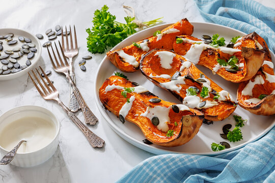Baked butternut squash halves with yogurt sauce