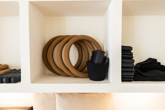 Pilates rings and workout equipment organized in cubbies