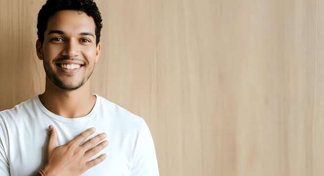 Happy Young Man with Warm Smile and Hand on Heart, Genuine Gratitude and Positive Expression Portrait