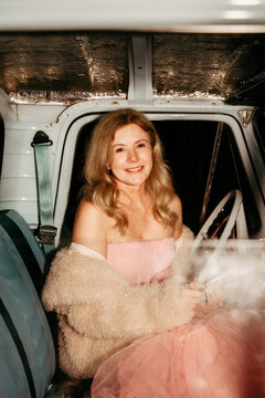 Woman dressed up in vintage truck