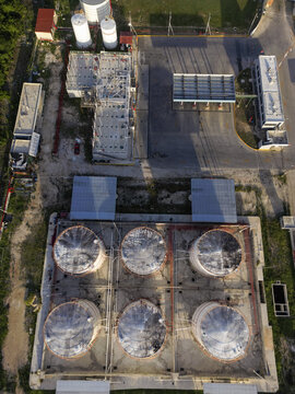 Aerial view of the Petroservicios Yucatan industrial facility featuring large storage tanks, a refueling station, and surrounding infrastructure in Progreso, Yucatan, Mexico.
