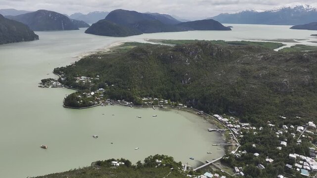 Aerial view of the remote coastal village of Caleta Tortel, showing wooden walkways and houses along the fiord at the Baker River delta in Patagonia, Chile.