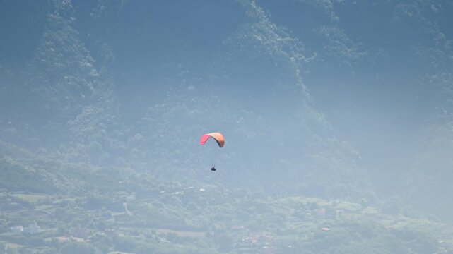 Paragliders Flying Over Mountain Landscape From Aerial Perspective
