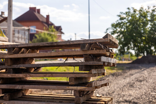 Workers prep for construction by wooden pallets