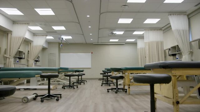 Physical Therapy Training Lab with Treatment Tables and Medical Equipment