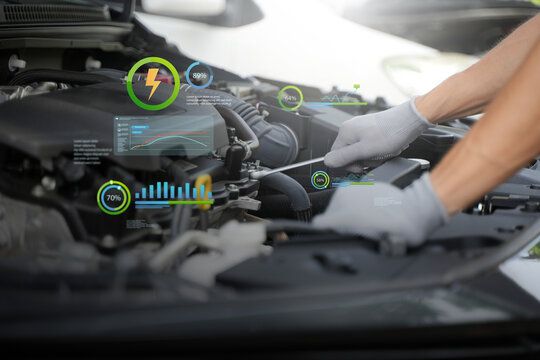 Automotive mechanics test customer service concepts using automotive diagnostic tools and artificial intelligence (AI) on laptops to verify quality.