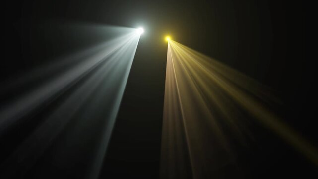 Orange and white spotlight beams shining down on black background.