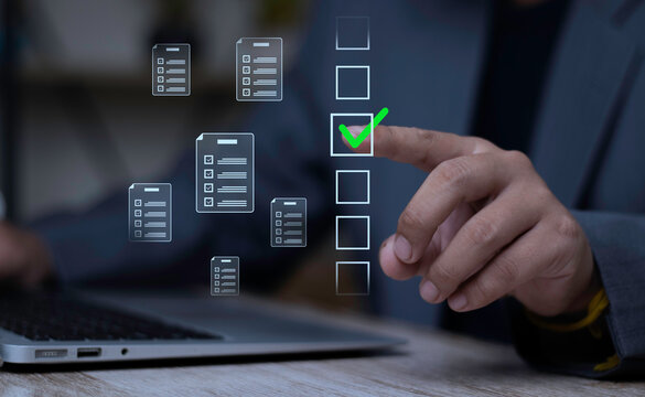 Businessman checking virtual boxes for online document approval, task management, and questionnaire survey on laptop. Concept of digital workflow, productivity, and quality control.