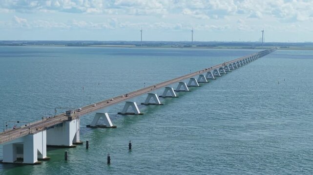 Aerial view of cars driving on the impressive Zeelandbrug bridge connecting islands in the Netherlands over the Oosterschelde