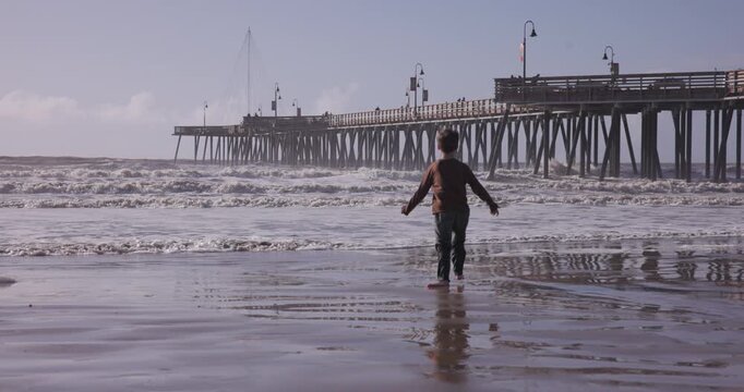 Autistic Boy Stimming with Excitement While Playing on Pismo Beach, California