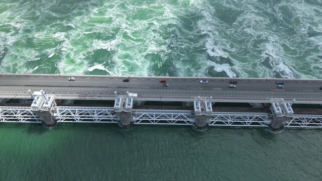Eastern Scheldt storm surge barrier in the Netherlands aerial view with flowing water and car traffic on the roadway