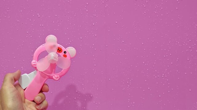 Hand fan helps cool down in the hot summer heat during a fun day outside