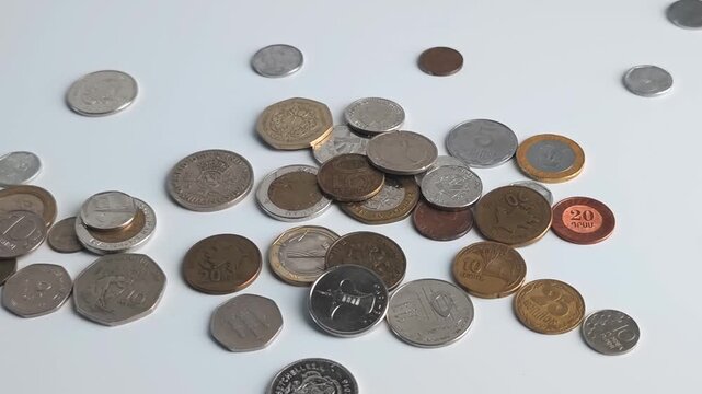 Hands sort different coins on a table in a simple arrangement process