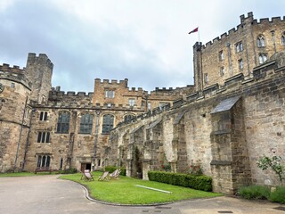 Fototapeta premium Enduring Medieval Palace Complex: A breathtaking distant perspective showcasing the magnificent terraced stone walls, complex architectural layers, and historic multi-level design of an ancient royal 