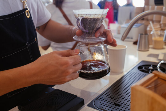 Barista Preparing Coffee Using a Pour-Over Method in a Cafe