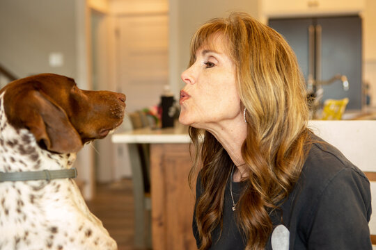 Happy Woman Playing with German Shorthaired Pointer