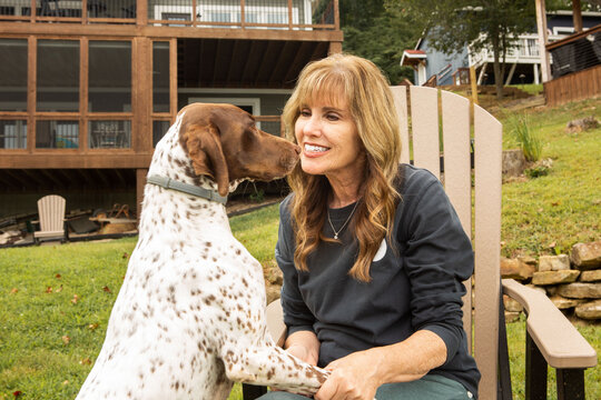Happy Woman Playing with German Shorthaired Pointer