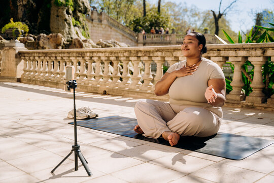 A woman does yoga in a city park