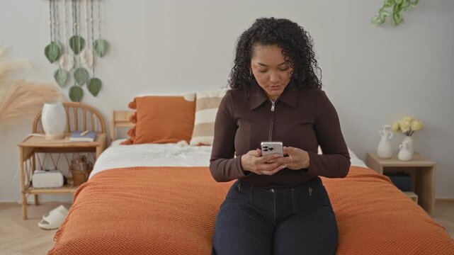 Woman on bed holds a smartphone in both hands, leans in and hugs a friend while they smile and share the screen in a studio bedroom setting; warm affection.