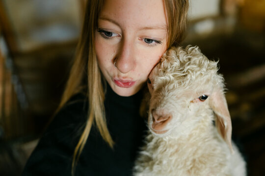 teen girl posing with Angora baby goat 