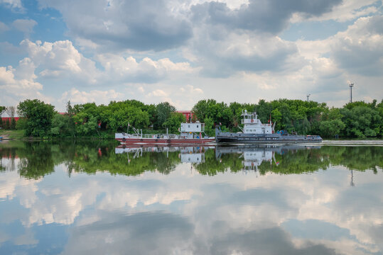 Pusher tug with barge on the river